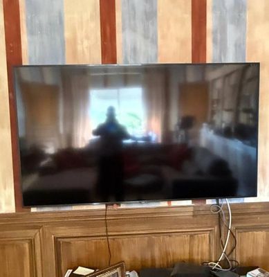 a flat screen tv sitting on a stand in a living room
