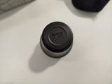 a bottle that is sitting on a desk next to a keyboard