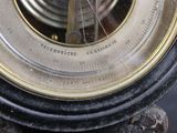 a close up of a clock on a stand