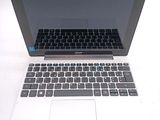 a laptop computer sitting on a table with a keyboard