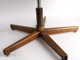 a wooden table with a black top and four wooden legs