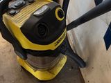 a yellow and black vacuum cleaner sitting on top of a wooden floor
