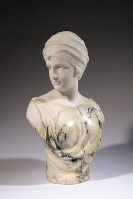 a marble bust of a woman with a turban on her head