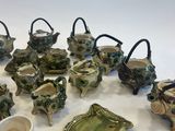 many pieces of pottery that are sitting on a table