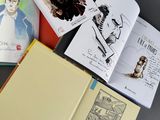 a lot of books that are open on a table