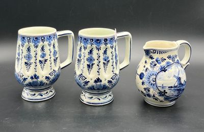 three blue and white vases sitting next to each other on a table