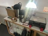 a table with a coffee pot, a coffee pot, and other items on it
