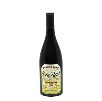 a bottle of wine sitting on top of a white table