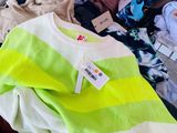 a shopping cart full of clothes and clothes for sale