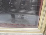 a picture of a man sitting on a bench in front of a mirror