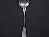 a spoon that is sitting on a black surface