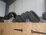 several tires are stacked on top of each other in a garage
