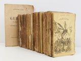 several old books sitting on top of a table next to each other