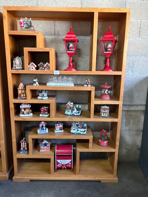 a wooden shelf with a lot of christmas decorations on it