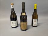 three bottles of wine sitting on a table next to each other