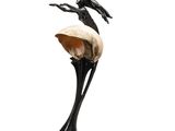 a statue of a bird sitting on top of a shell