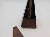 a small wooden instrument with a triangle on it
