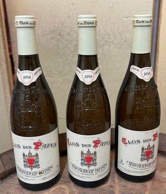 three bottles of wine sitting on top of a wooden barrel