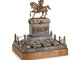 statue d'un homme à cheval sur un socle, entourée d'une chaîne