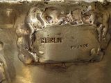 a close up of a silver plate with a dog on it