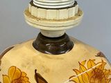 a vase with a flower design on it sitting on a table