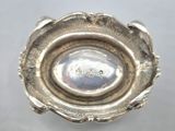 a silver bowl that is sitting on top of a table