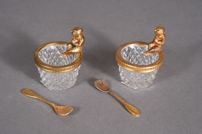 two cups and spoons sitting on a table