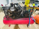 a red air compressor with a basket full of air compressors