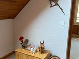 an image of a bedroom with a bed and a dresser in it
