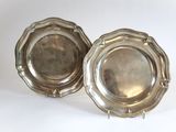 pair of silver plated dishes on stands on a white surface
