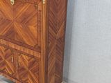 a small chest of drawers in the corner of a room