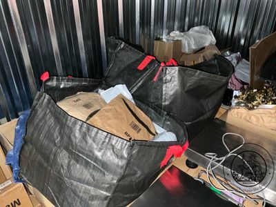 two bags of garbage sitting on a table in a room