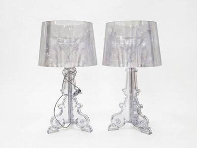 pair of clear glass table lamps with silver shades on a white background