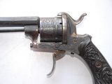 an old gun with a wooden handle on a white surface