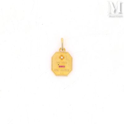 a close up of a small gold plated pendant on a white background