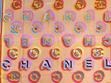 a scarf with letters and a chanel logo on it