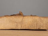 an old piece of wood sitting on top of a table