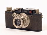 a black and silver camera on a white background
