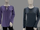 three mannequins wearing different colored shirts and black pants