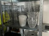 a metal shelf filled with pots and pans