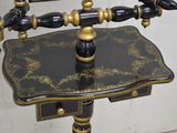 a black and gold desk with a mirror on it