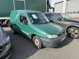 a green van that is parked next to other cars