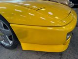 a yellow sports car parked in a parking lot