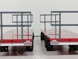 two red flatbeds that are sitting side by side