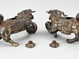 these are two figurines of a horse and a dog on a white surface