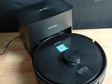 an image of a small black speaker sitting on top of a wooden table