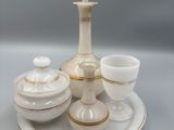 a white and gold tea set on a white plate