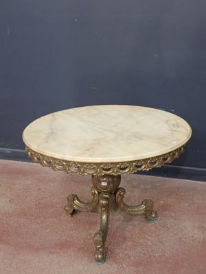 an image of a table with a marble top on a carpeted floor
