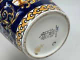 a blue and gold vase with a dragon on it