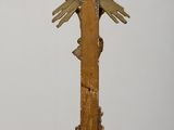 a wooden cross on a table with a bird on it